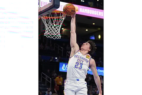 Oklahoma City Thunder forward Brooks Barnhizer dunks during the second half of an NBA basketball game against the Phoenix Suns in Oklahoma City.