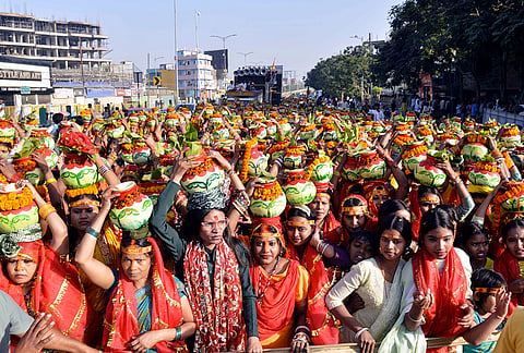 Women carrying water of River Ganga take part in 'Kalash Yatra' religious procession on the ocassion of ‘Satuani’ festival, in Patna, Bihar.