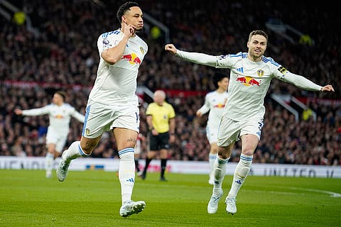 Leeds' Noah Okafor, left, celebrates after scoring the opening goal during the Premiier League soccer match between Manchester United and Leeds in Manchester, England.