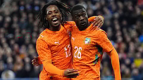Ivory Coast's Nicolas Pepe, right, celebrates scoring their side's first goal of the game during an international friendly match between Scotland and Ivory Coast in Liverpool, England, Tuesday, March 31, 2026.