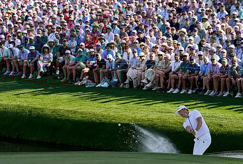 Haotong Li, of China, hits from the bunker on the 16th hole during the final round of the Masters golf tournament at the Augusta National Golf Club, in Augusta, Georgia.