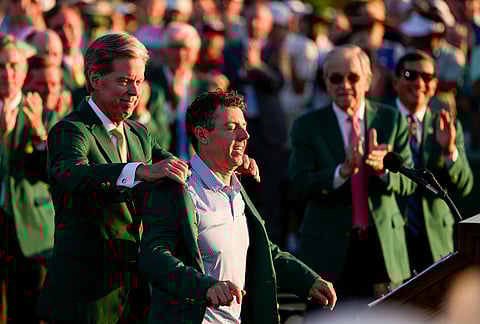 Augusta National Golf Club chairman Fred Ridley puts the green Jacket on Rory McIlroy, of Northern Ireland, after the Masters golf tournament at the Augusta National Golf Club in Augusta, Georgia.