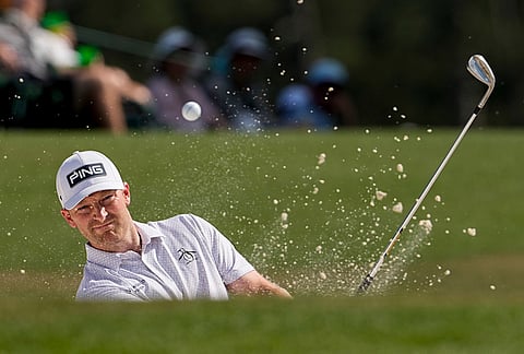Brian Campbell hits from the bunker on the 18th hole during the final round of the Masters golf tournament at the Augusta National Golf Club, in Augusta, Georgia.