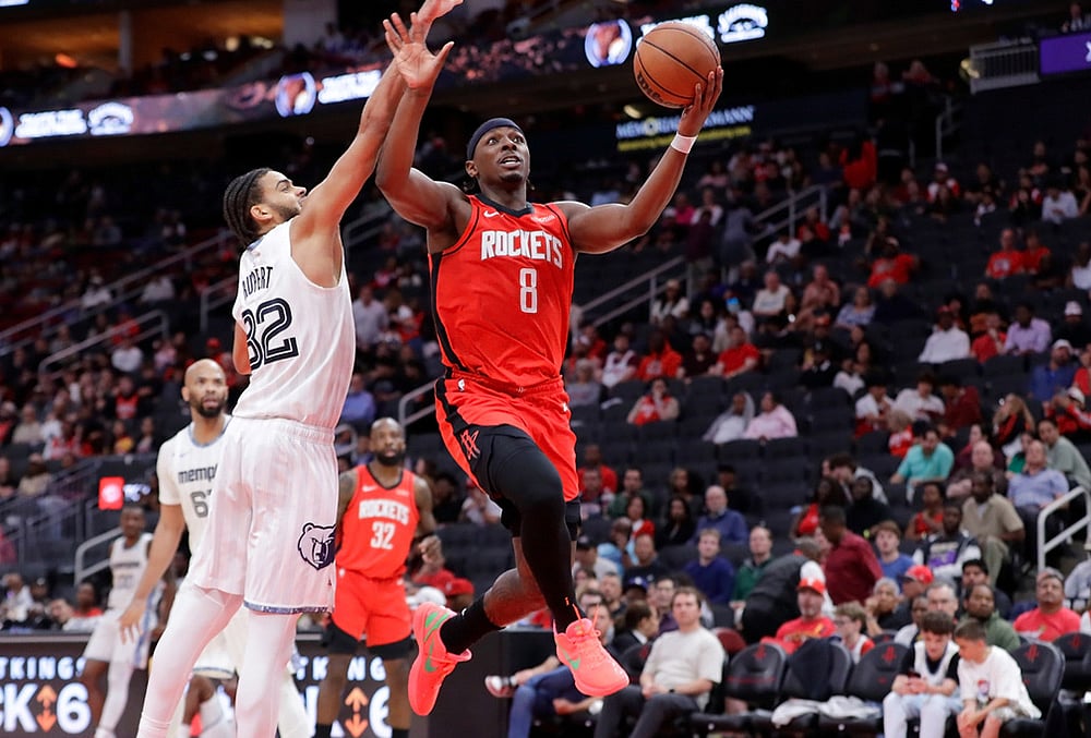 Houston Rockets forward Jae'sean Tate (8) puts up a shot pastMemphis Grizzlies guard Rayan Rupert (32) during the second half of an NBA basketball game in Houston.  - | Photo: AP/Michael Wyke