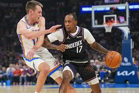 Phoenix Suns guard Jamaree Bouyea, right, pushes past Oklahoma City Thunder forward Payton Sandfort during the first half of an NBA basketball game in Oklahoma City.