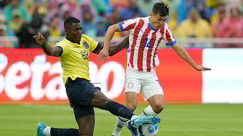 Ecuador's Moises Caicedo tackles Paraguay's Andres Cubas during a qualifying soccer match for the FIFA World Cup 2026 at Rodrigo Paz Delgado stadium in Quito, Ecuador, Thursday, Oct. 10, 2024.
