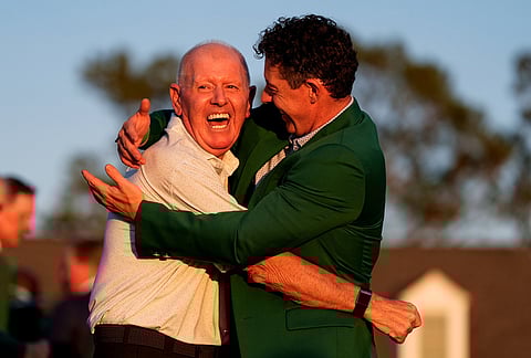 Rory McIlroy, of Northern Ireland, hugs his father Gerry McIlroy after winning the Masters golf tournament at the Augusta National Golf Club, in Augusta, Georgia. 