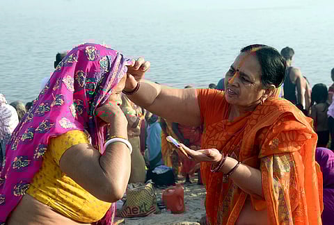 Women perform rituals at the banks of River Ganga during ‘Satuani’ festival, in Patna, Bihar. 
