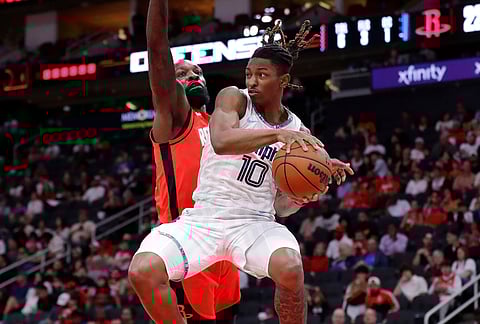 Memphis Grizzlies guard Javon Small (10) goes up to pass the ball in front of Houston Rockets forward Jeff Green, left, during the first half of an NBA basketball game in Houston. 