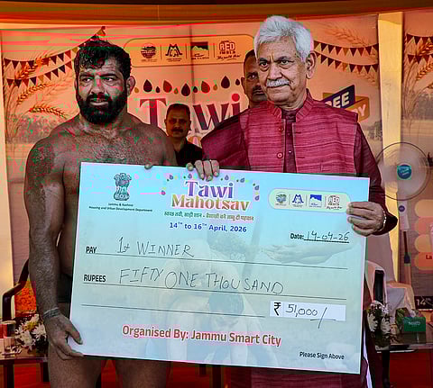 Jammu and Kashmir LG Manoj Sinha presents a cheque to a wrestler during the Tawi Mahotsav as part of the ‘Baisakhi’ festival celebrations, near Tawi riverfront in Jammu.