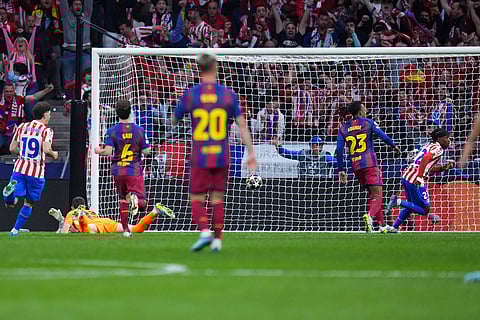 Atletico Madrid's Ademola Lookman, right, celebrates after scoring his side's opening goal during the Champions League quarterfinal second leg soccer match between Atletico Madrid and Barcelona in Madrid, Spain.