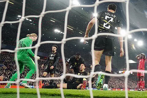 PSG's goalkeeper Matvey Safonov and Marquinhos react after a save during the Champions League quarterfinal second leg soccer match between Liverpool and Paris Saint-Germain in Liverpool, England.