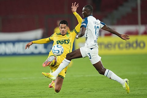 Lucas Oliveira of Brazil's Mirassol, left, and Janner Corozo of Ecuador's Liga Deportiva Universitaria battle for the ball during a Copa Libertadores Group G soccer match in Quito, Ecuador.