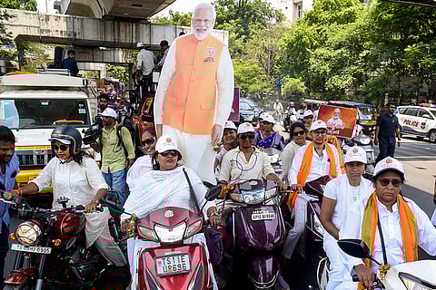 Women take part in a women's scooty rally organised by BJP Yuva Morcha in support of the 'Nari Shakti Vandan Adhiniyam', in Hyderabad, Telangana.