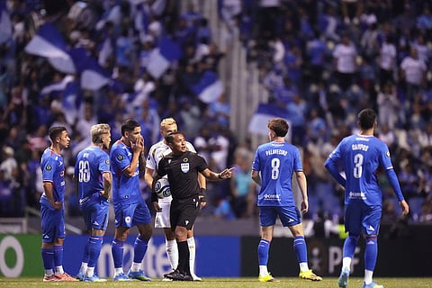 Referee Ivan Barton suspends the match due to discriminatory chants from the crowd during a CONCACAF Champions Cup quarterfinal second leg soccer match between Mexico's Cruz Azul and the United States' Los Angeles FC in Puebla, Mexico.