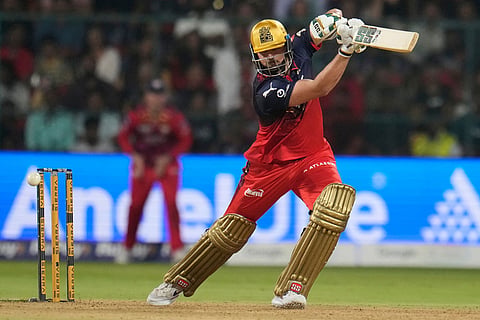 Royal Challengers Bengaluru's Tim David plays a shot during the Indian Premier League cricket match between Royal Challengers Bengaluru and Lucknow Super Giants in Bengaluru, India.