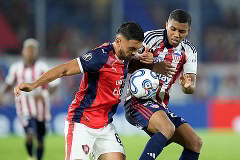 Brian Luciatti of Paraguay's Cerro Porteño, left, and Jesus Rivas of Colombia's Junior battle for the ball during a Copa Libertadores Group F soccer match in Asuncion, Paraguay.