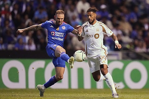 Rodolfo Rotondi of Mexico's Cruz Azul, left, and Denis Bouanga of the United States' Los Angeles FC compete for the ball during a CONCACAF Champions Cup quarterfinal second leg soccer match in Puebla, Mexico.
