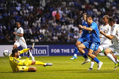 Andres Montano of Mexico's Cruz Azul (10) attempts a shot on goal in front of Hugo Lloris goalkeeper of the United States' Los Angeles FC during a CONCACAF Champions Cup quarterfinal second leg soccer match in Puebla, Mexico.