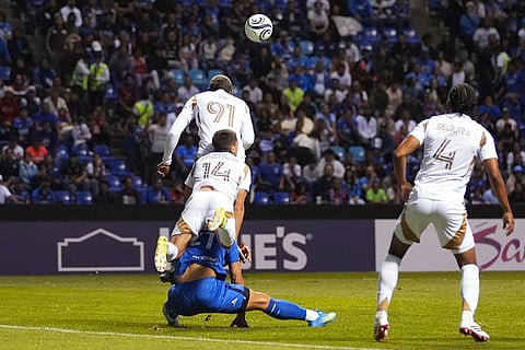 Gabriel Fernandez of Mexico's Cruz Azul, bottom, is fouled for a penalty kick by Sergi Palencia of the United States' Los Angeles FC (14) during a CONCACAF Champions Cup quarterfinal second leg soccer match in Puebla, Mexico.