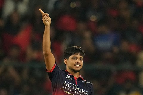 Royal Challengers Bengaluru's Rasikh Salam celebrates the wicket of Lucknow Super Giants' Aiden Markram during the Indian Premier League cricket match between Royal Challengers Bengaluru and Lucknow Super Giants in Bengaluru, India.