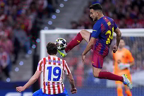Barcelona's Eric Garcia, right, and Atletico Madrid's Julian Alvarez challenge for the ball during the Champions League quarterfinal second leg soccer match between Atletico Madrid and Barcelona in Madrid, Spain.