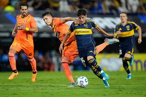 Tomas Aranda of Argentina's Boca Juniors, right, and Luca Sosa of Ecuador's Barcelona vie for the ball during a Copa Libertadores Group D soccer match in Buenos Aires, Argentina.