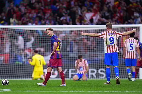 Barcelona's Frenkie de Jong, center, reacts at the end of the Champions League quarterfinal second leg soccer match between Atletico Madrid and Barcelona in Madrid, Spain.