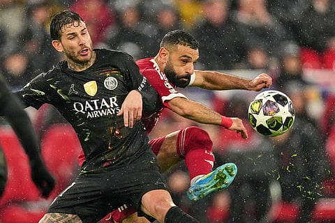PSG's Lucas Hernandez, left, and Liverpool's Mohamed Salah battle for the ball during the Champions League quarterfinal second leg soccer match between Liverpool and Paris Saint-Germain in Liverpool, England.