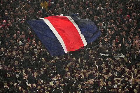 PSG fans wave a flag during the Champions League quarterfinal second leg soccer match between Liverpool and Paris Saint-Germain in Liverpool, England.