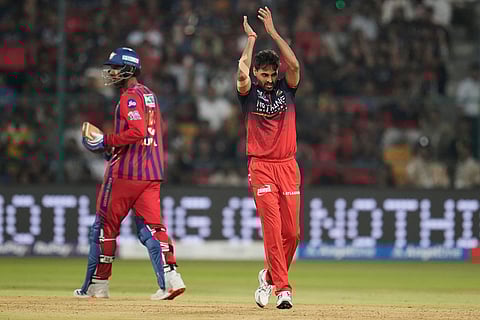 Royal Challengers Bengaluru's Bhuvneshwar Kumar, right, celebrates the dismissal of Lucknow Super Giants' captain Rishabh Pant during the Indian Premier League cricket match between Royal Challengers Bengaluru and Lucknow Super Giants in Bengaluru, India.