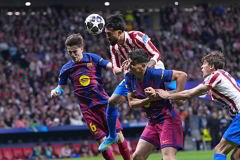 Atletico Madrid's Nicolas Gonzalez, top, heads the ball during the Champions League quarterfinal second leg soccer match between Atletico Madrid and Barcelona in Madrid, Spain.