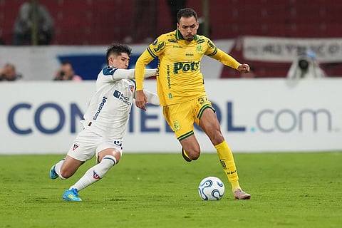 Eduardo of Brazil's Mirassol, right, controls the ball challenged by Fernando Cornejo of Ecuador's Liga Deportiva Universitaria during a Copa Libertadores Group G soccer match in Quito, Ecuador.