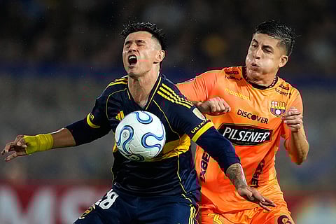 Luca Sosa of Ecuador's Barcelona pushes Adam Bareiro of Argentina's Boca Juniors during a Copa Libertadores Group D soccer match in Buenos Aires, Argentina.