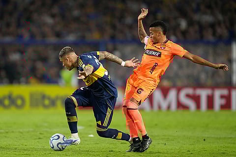 Ayrton Costa of Argentina's Boca Juniors dribbles past Byron Castillo of Ecuador's Barcelona during a Copa Libertadores Group D soccer match in Buenos Aires, Argentina.