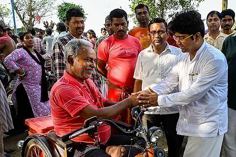 TMC candidate for the Santipur Assembly constituency, Braja Kishore Goswami, right, meets the ferry workers on the occasion of ‘Poila Boishakh’ (Bengali New Year) as part of an election campaign ahead of the West Bengal Assembly Election, in Nadia district.