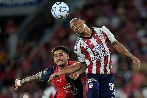 Jonatan Torres of Paraguay's Cerro Porteño, left, and Jermein Pena of Colombia's Junior go for a header during a Copa Libertadores soccer match in Asuncion, Paraguay.