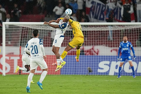 Deyverson Brum of Ecuador's Liga Deportiva Universitaria, top left, and Lucas Oliveira of Brazil's Mirassol go for a header during a Copa Libertadores Group G soccer match in Quito, Ecuador.