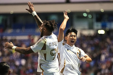Son Heung-Min, right, congrats Denis Bouanga of the United States' Los Angeles FC after scoring his side's first goal against Mexico's Cruz Azul during a CONCACAF Champions Cup quarterfinal second leg soccer match in Puebla, Mexico.