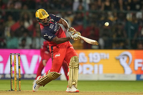 Royal Challengers Bengaluru's Romario Shepherd hits a six during the Indian Premier League cricket match between Royal Challengers Bengaluru and Lucknow Super Giants in Bengaluru, India.