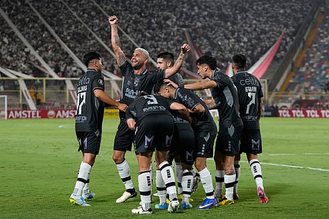 Cristian Zavala of Chile's Coquimbo Unido celebrates with teammates after scoring his side's opening goal against Peru's Universitario during a Copa Libertadores Group B soccer match in Lima, Peru.