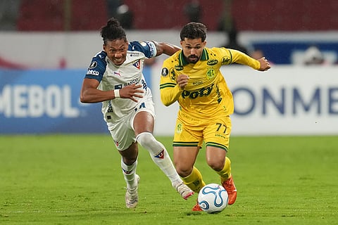 Jose Quintero of Ecuador's Liga Deportiva Universitaria, left, and Alesson of Brazil's Mirassol vie for the ball during a Copa Libertadores Group G soccer match in Quito, Ecuador.