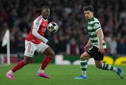 Arsenal's Eberechi Eze, left, and Sporting's Pedro Goncalves go for the ball during the UEFA Champions League second leg quarterfinal soccer match between Arsenal and Sporting in London, England.