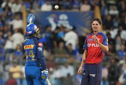 Mumbai Indians' Ryan Rickelton hands over the ball to Punjab Kings' Marco Jansen during the Indian Premier League cricket match between Mumbai Indians and Punjab Kings in Mumbai.