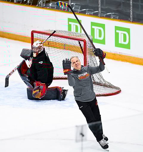Canada's Prime Minister Mark Carney reacts after missing a shot on net against Ottawa Charge goaltender Gwyneth Philips (33) as he takes part in an Ottawa Charge practice with President of Finland Alexander Stubb, in Ottawa.