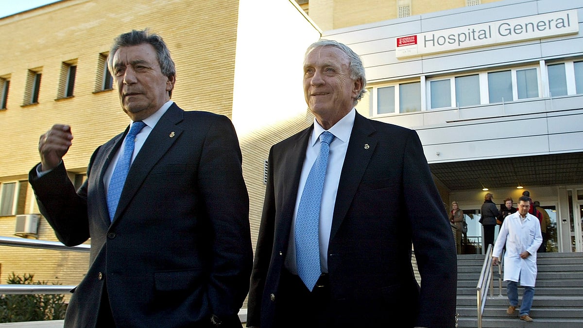 FILE -Former Real Madrid soccer players Enrique Perez "Pachin", left, and Jose Emilio Santamaria leave La Fe hospital in Valencia, Spain, Dec. 27, 2005 after visiting their former teammate Alfredo di Stefano, of Argentina.  - (AP Photo/Fernando Bustamante, File)