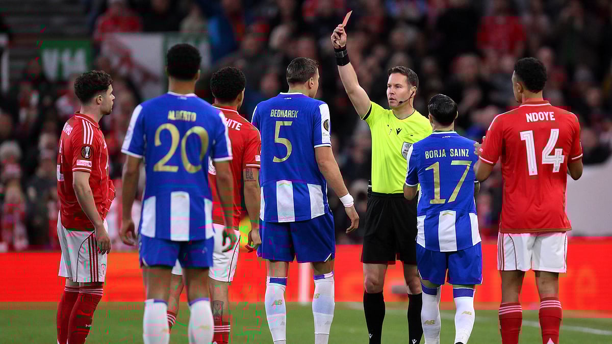 Jan Bednarek, center, is shown a red card and sent off by referee Danny Makkelie during the Europa League quarterfinal second leg soccer match. - Gary Oakley/PA via AP