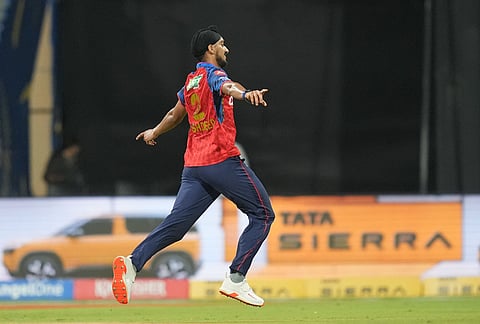 Punjab Kings' Arshdeep Singh, left, celebrates the wicket of Mumbai Indians' Suryakumar Yadav during the Indian Premier League cricket match between Mumbai Indians and Punjab Kings in Mumbai.