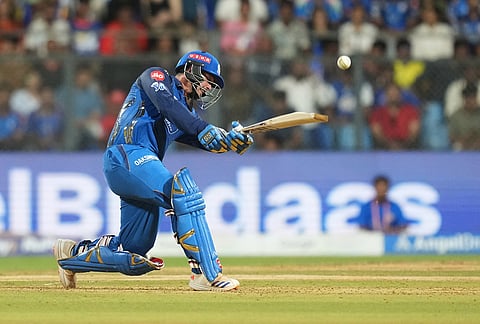 Mumbai Indians' wicketkeeper Quinton de Kock hits a six during the Indian Premier League cricket match between Mumbai Indians and Punjab Kings in Mumbai.