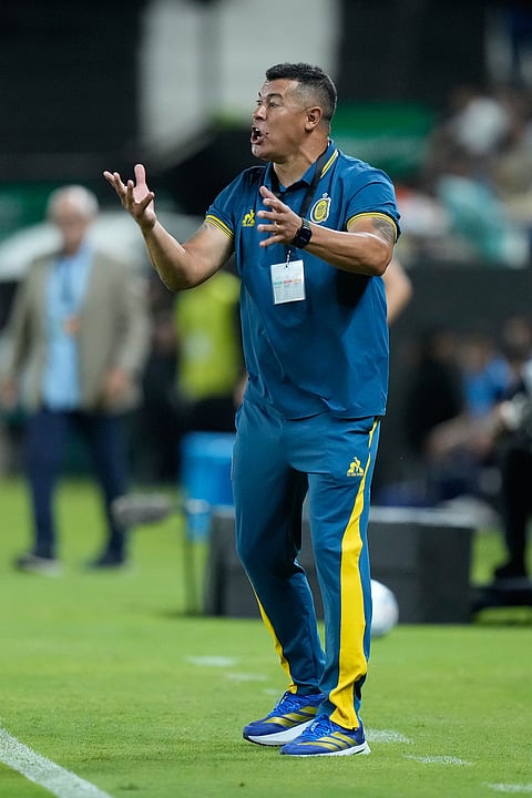 Coach Jorge Almiron of Argentina's Rosario Central instructs his players during a Copa Libertadores Group H soccer match against Paraguay's Libertad in Asuncion, Paraguay.

